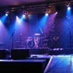 Corporate event branding setup with a branded stage and banners.