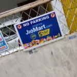 A branded no parking board installed outside a retail store, ensuring brand visibility to customers and passersby