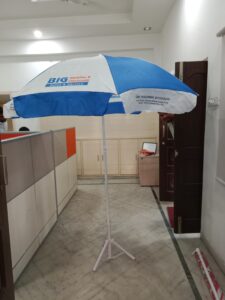 Promotional Umbrella - Branded promotional umbrella used outside a retail store for advertising.
