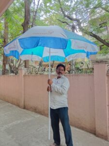Promo umbrella used at a roadside vendor stall for brand advertising.