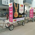 Tri cycles advertising for a bank promoting a new savings scheme