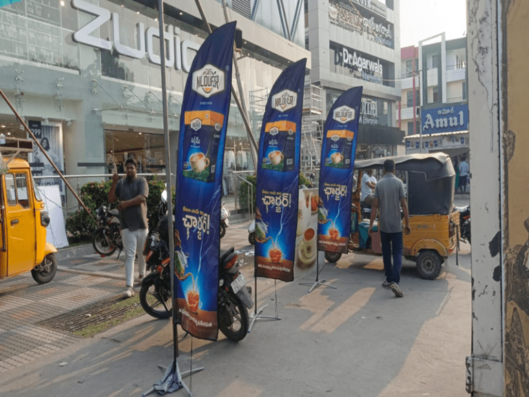 Feather flag advertising at a trade show, attracting customer attention.