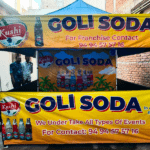 A fully customized gazebo with a company logo and promotional banners set up at a trade fair.