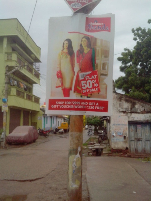 A vibrant pole banner advertisement displayed on a busy street, attracting pedestrians and motorists