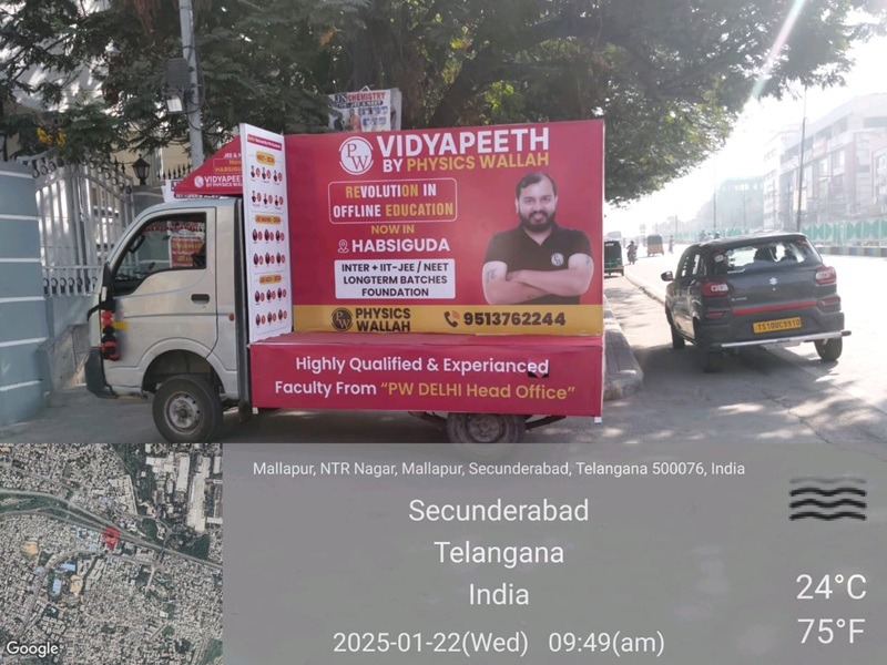 A branded Tata Ace vehicle positioned in a busy shopping district, increasing brand visibility among shoppers and business owners
