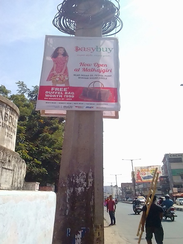 Multiple pole banners at a shopping mall entrance promoting a brand