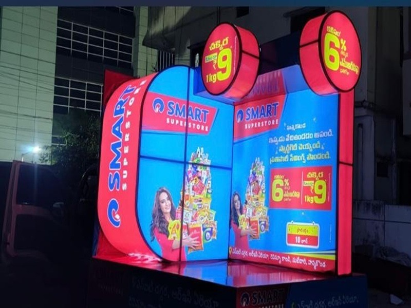 A branded Tata Ace vehicle parked in a crowded market, ensuring maximum visibility for the advertisement