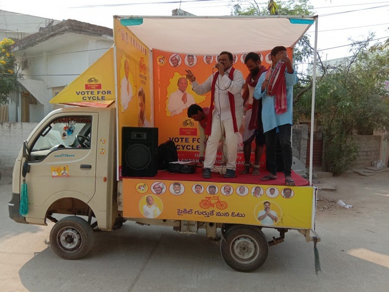 An Canter Van / Promo Van Advertising displaying a digital advertisement at a busy market junction
