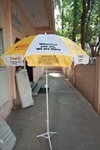 Branded promotional umbrella used outside a retail store for advertising.