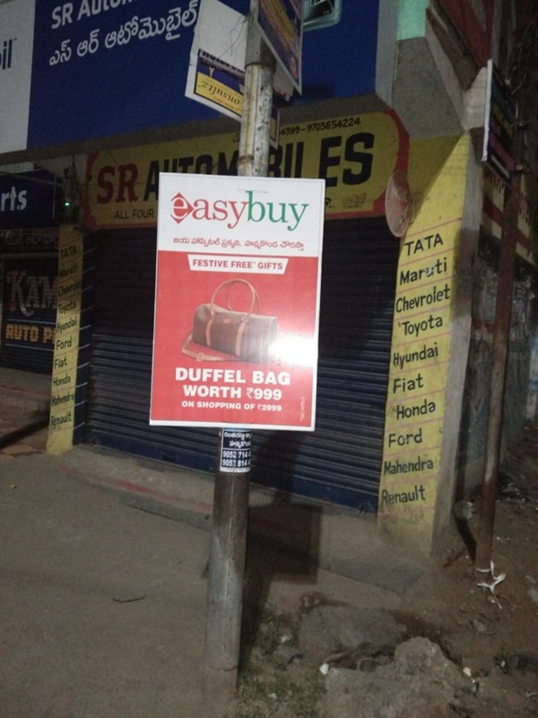 Pole boards promoting a retail chain in Andhra Pradesh for hyperlocal marketing.