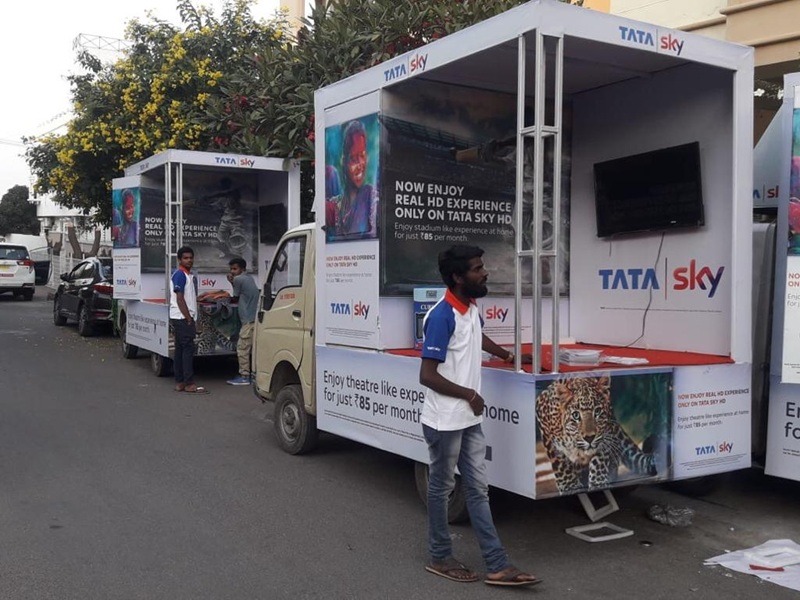 A Canter Van equipped with speakers for a live audio campaign in a crowded street