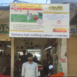 Co-branding flex boards advertising displayed on a busy marketplace street.