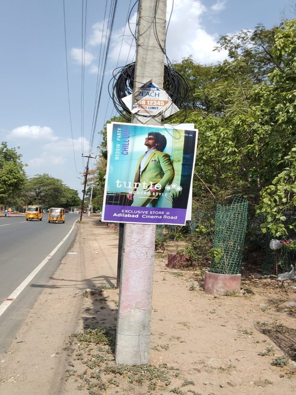 A series of pole boards promoting a financial institution in Telangana.