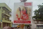 A vibrant pole banner advertisement displayed on a busy street, attracting pedestrians and motorists