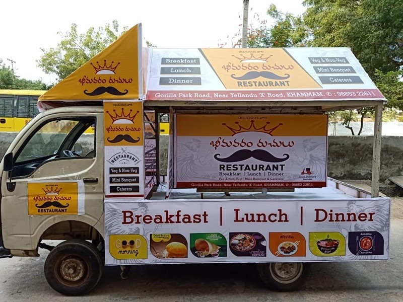 A Canter Van displaying a bank’s loan offer while moving through a busy commercial district