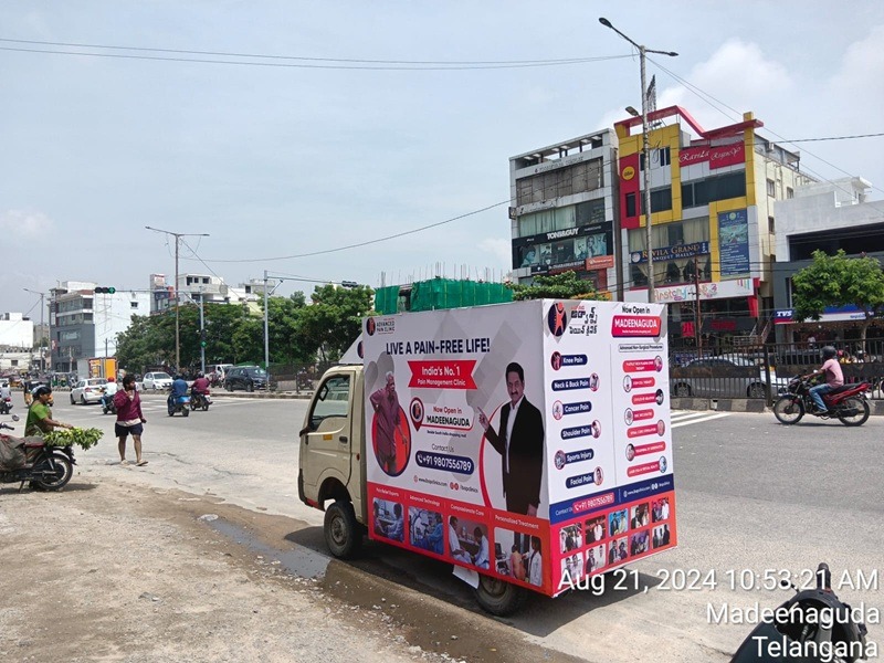 A Canter Van with political party branding, featuring loudspeakers and a candidate’s image