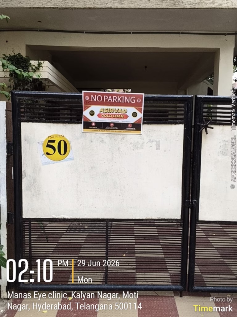 No Parking board advertisement for Asirvad Gold Loan displayed on a residential gate in Kalyan Nagar, Moti Nagar, Hyderabad, offering local brand visibility.